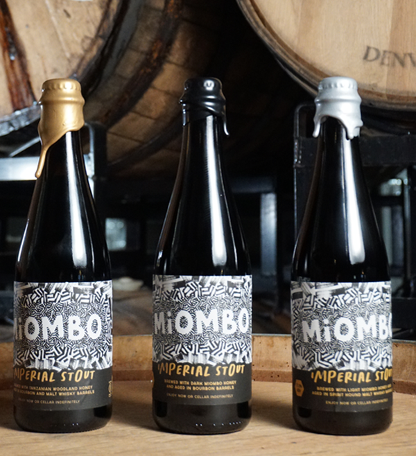 Three bottles of Miombo Imperial Stout on barrel